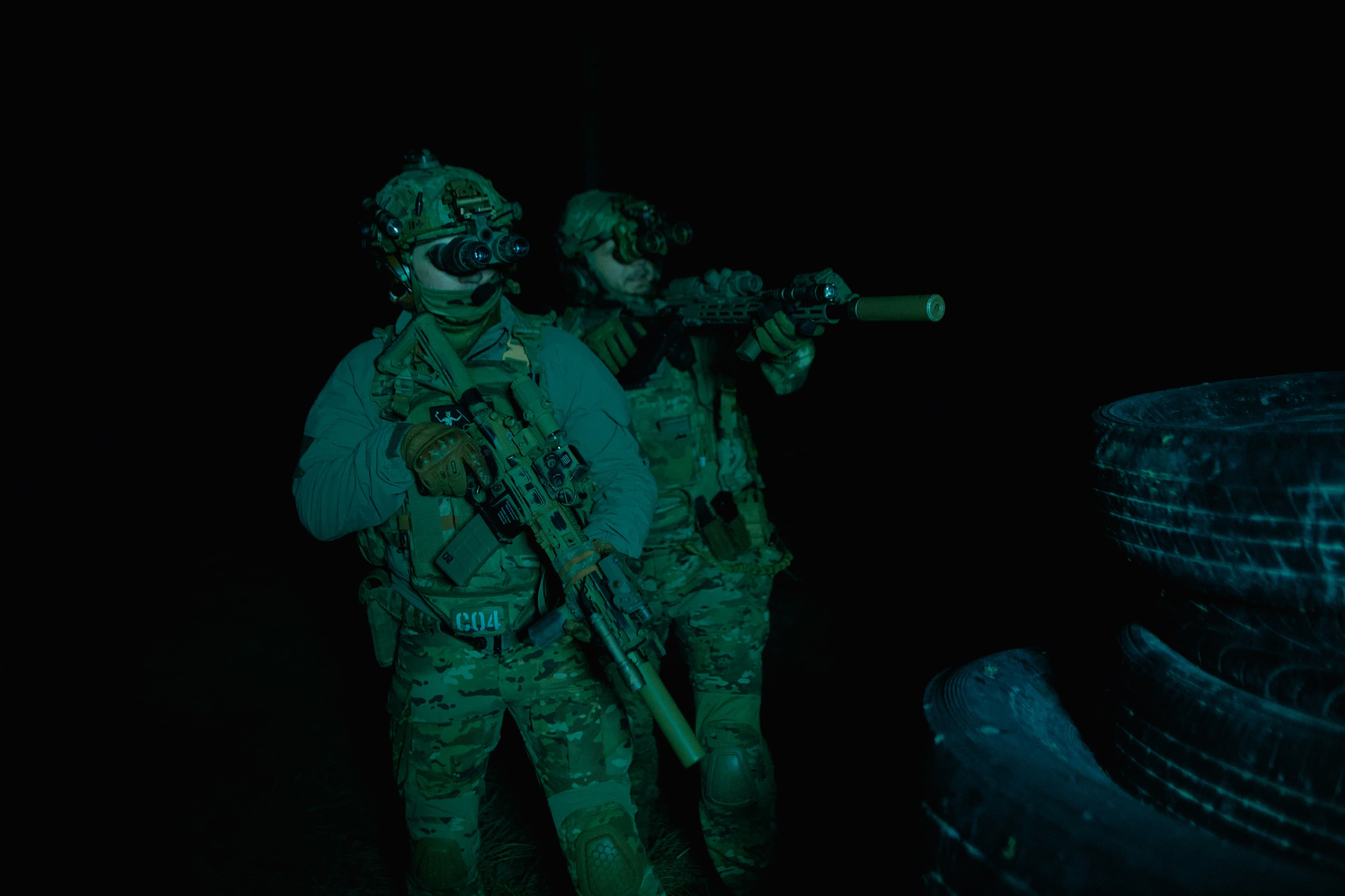 Special operations operators equipped with night-vision goggles conducting a night operation